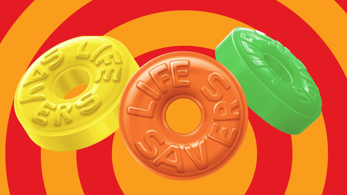 Yellow, orange, and green Life Savers hard candy on colorful background