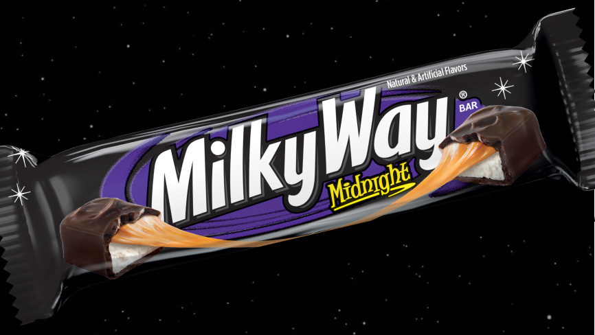 Packaged Midnight Milkyway bar on dark celestial background