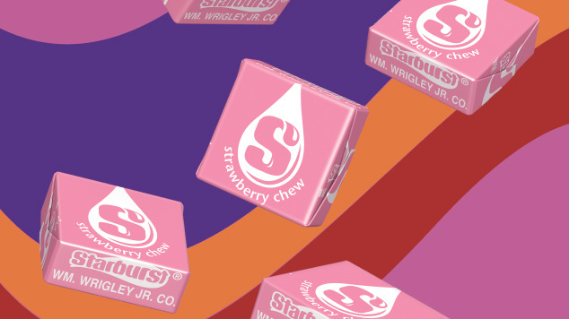 Five pink starburst individually wrapped, floating in front of a purple, orange, red, and pink swirly background 