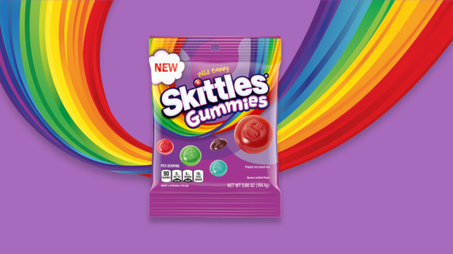 Skittles wild berry gummies with purple and rainbow background 