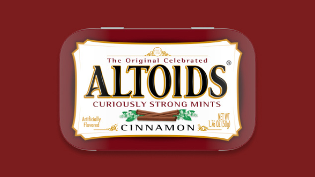 Tin of Cinnamon Altoids on a dark red background