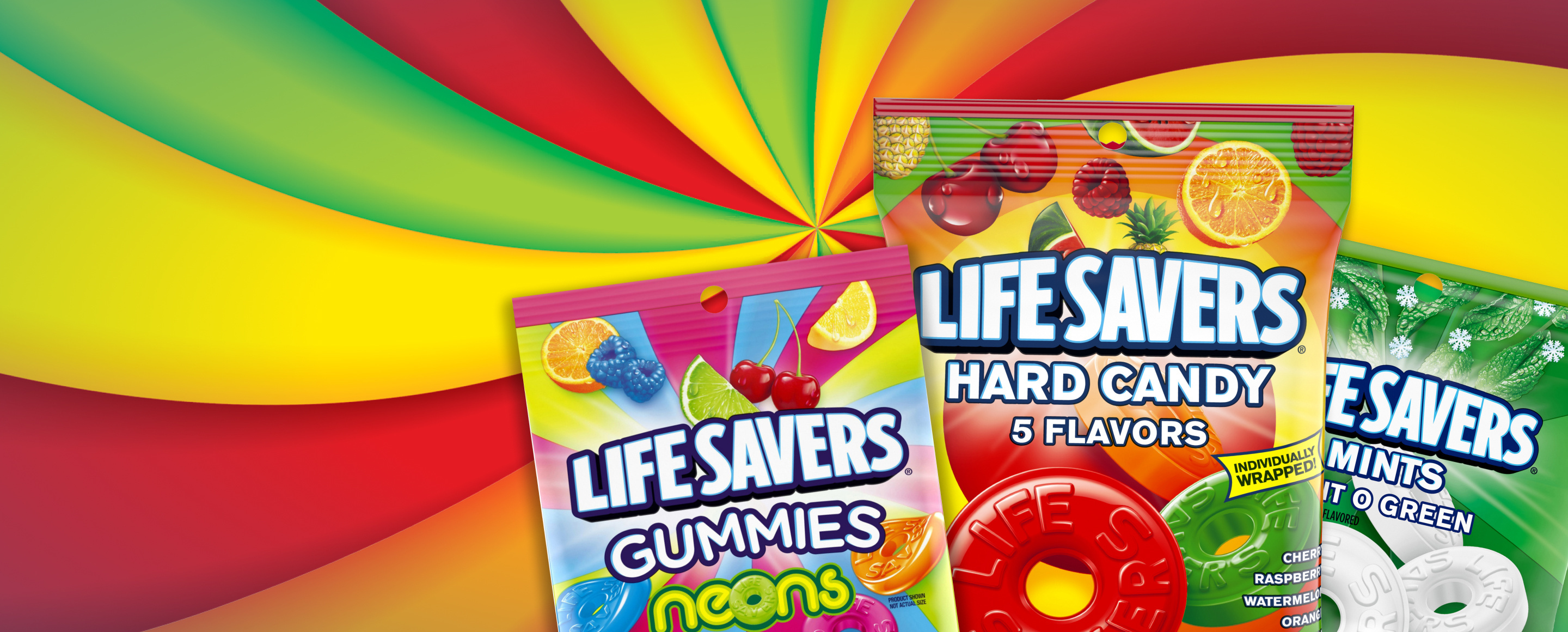 Three packages of various LIfe Savers candies in front of colored swirl