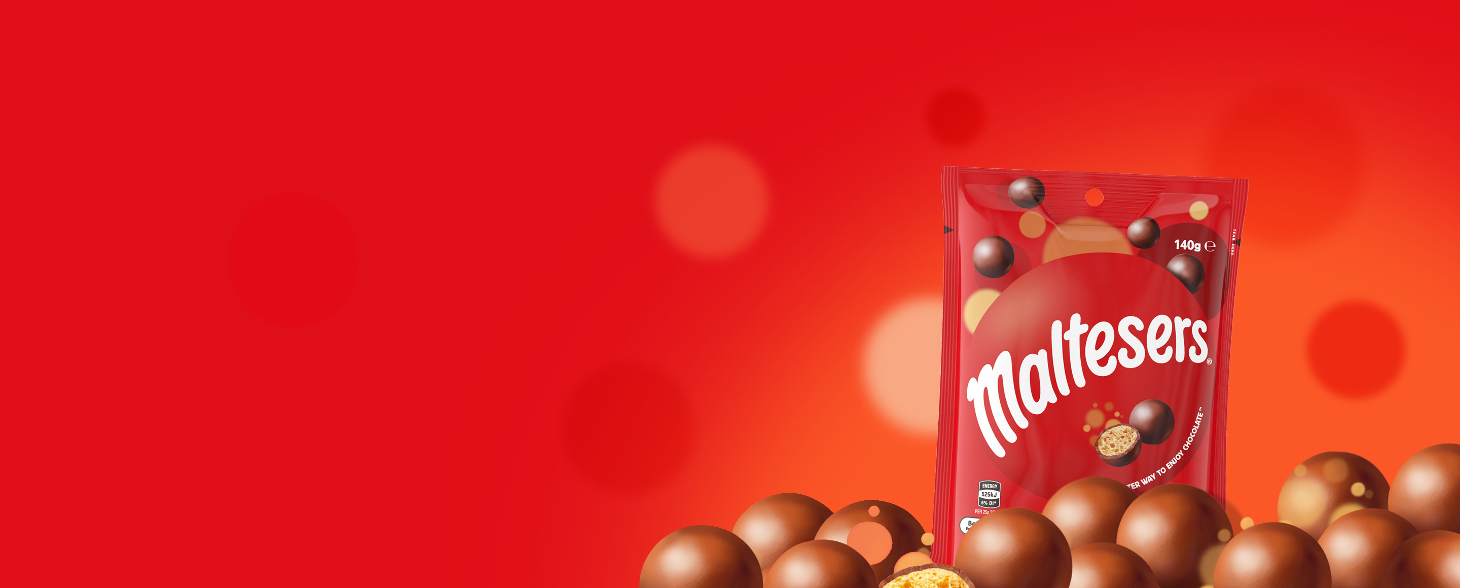 Maltesers bag floating above a pile of Maltesers on a red background with ball pattern