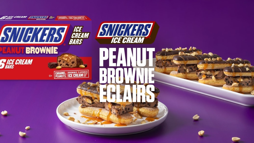 Plate of Snickers peanut brownie ice cream eclairs with text overlay