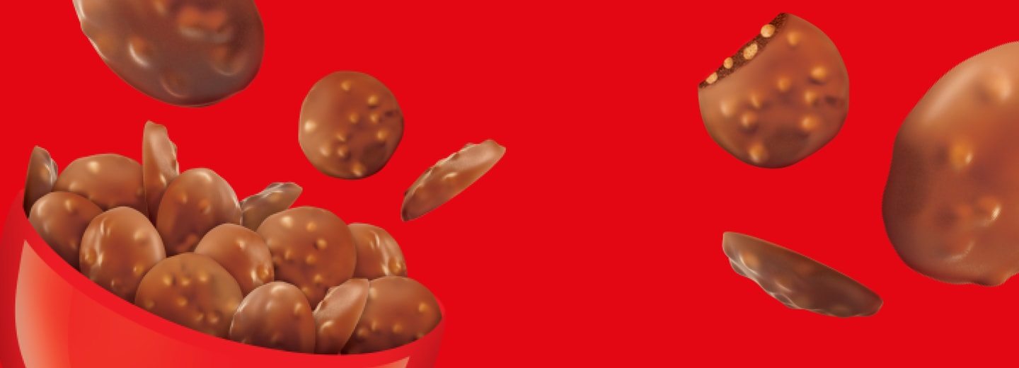 Maltesers Buttons falling into a bowl against a red background