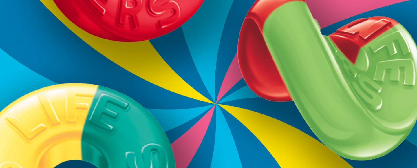 Zoomed in multi-colored Life Savers gummies on top of colorful swirled background