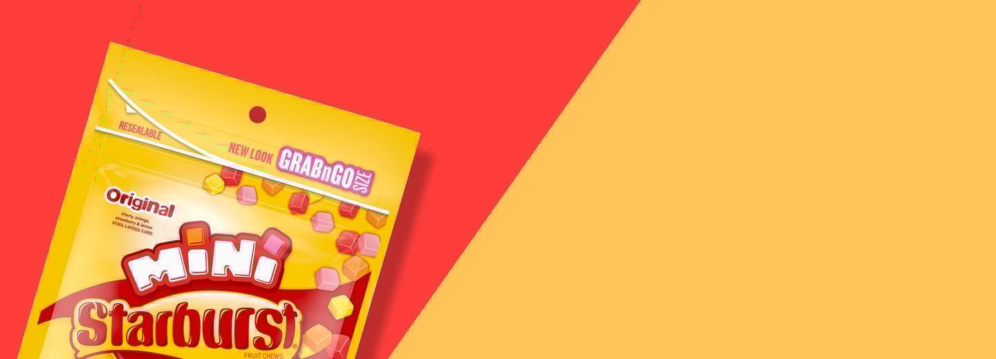 Pack shot of Grab n Go Size bag of Starburst minis on a sliced red and yellow background