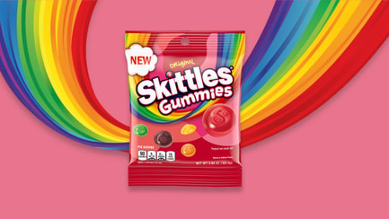 Skittles gummies original bag with pink and rainbow background 