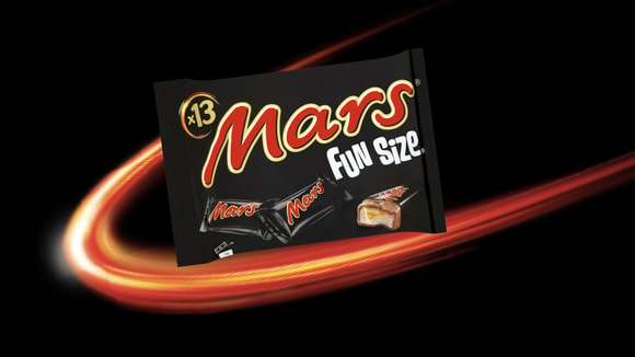 Packaged bag of Mars fun size chocolate bars in front of celestial background
