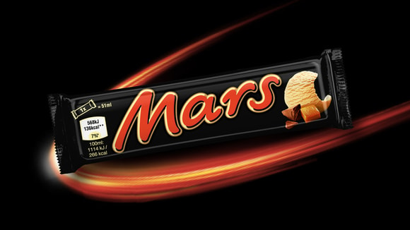 Packaged Mars ice cream bar in front of celestial background
